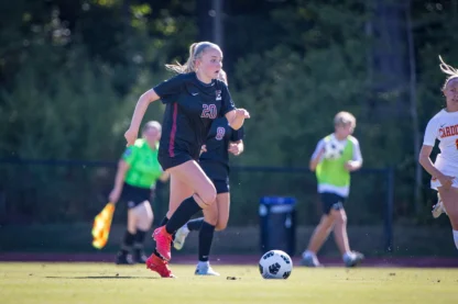 girls playing soccer at summer camp